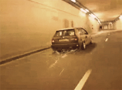  A picture of a car driving through a tunnel as sparks fly out the back of it 